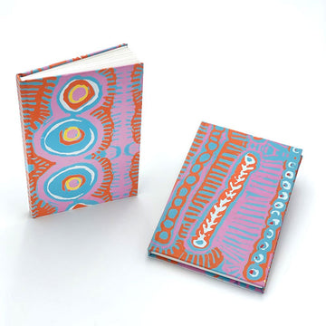 Two colorful notebooks with First Nations patterns  in blue, orange and purple on a white background.