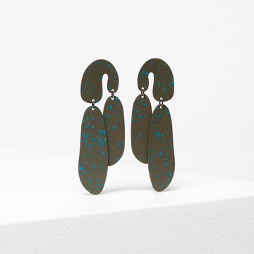 A pair of drop earrings in olive green with blue speckles in an arch shape.