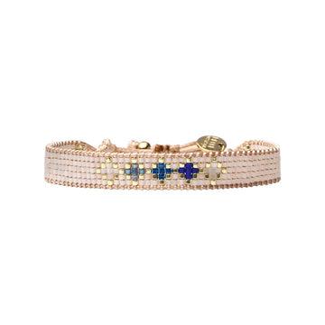 A thick beaded bracelet in beige beads with blue accents.