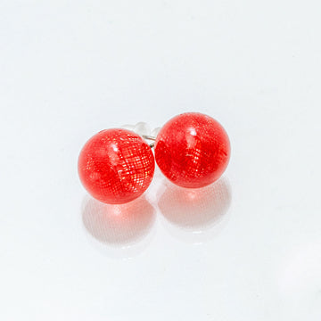 Pair of red spherical earrings on a white background.