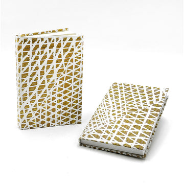 Two notebooks pictured, one is laying down and the other is standing up. They are printed with artwork by Paulina Puruntatameri.