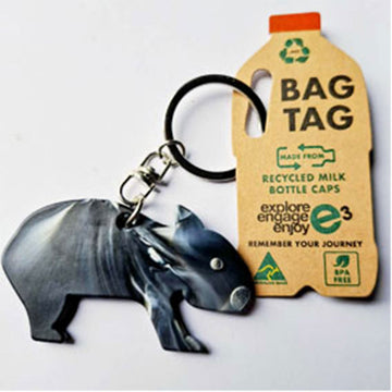 Keychain with animal design and recycled milk bottle cap bag tag on a white background.