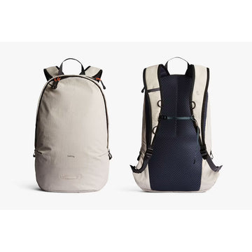 Beige backpack with black straps on a white background.