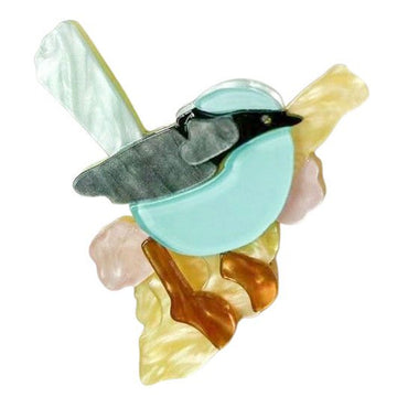 A resin brooch shaped like a blue wren.