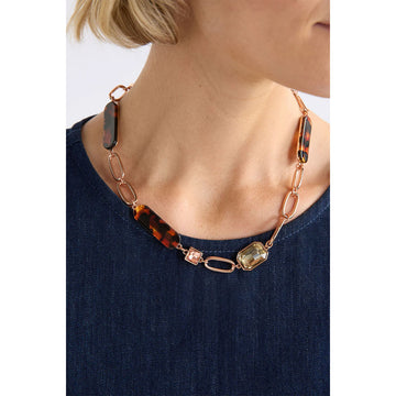 Necklace with green and silver links on a white background.