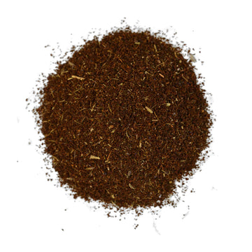 A purple box of tea sitting behind a bunch of blueberries.