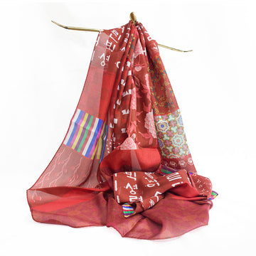 A red patterned scarf draped over a gold stand.