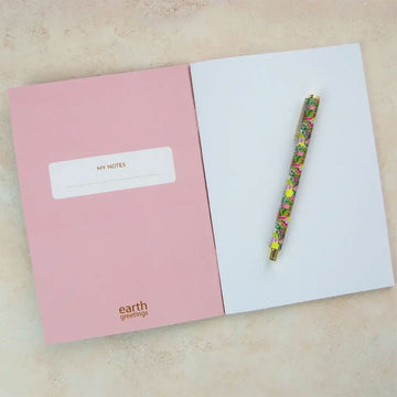 A notebook illustrated with flowers on a dark blue cover.