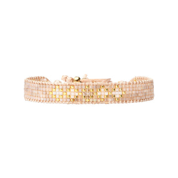 Beaded bracelet with gold accents on a white background.