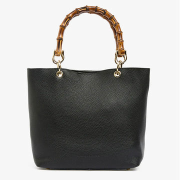 Front view of a black leather tote bag with round bamboo handles.