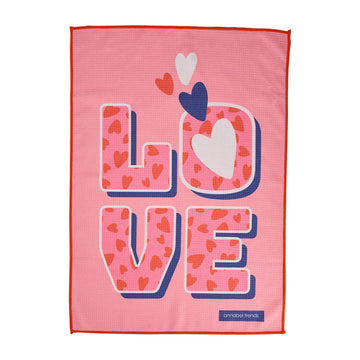 One side of a waffle textured tea towel with the word 'LOVE' written and printed with hearts.