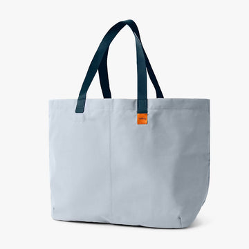 Light blue tote bag with blue handles on a white background.