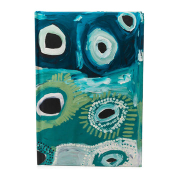 A hardcover journal printed with artwork by May Wokka Chapman on the front in blue and green.