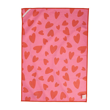 One side of a waffle textured tea towel with the word 'LOVE' written and printed with hearts.