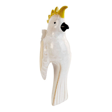 A ceramic cockatoo designed to sit on the side of a pot.