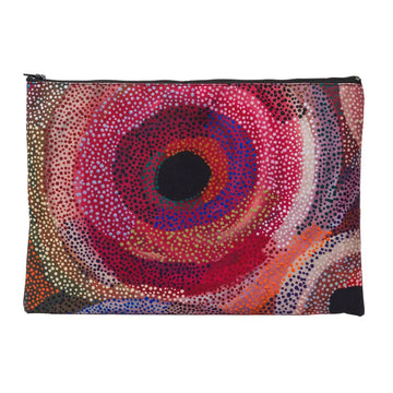 A zippered purse printed with artwork by Marianne Burton featuring circles in shades of red.