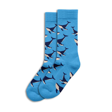 Blue socks with whale pattern on a white background.