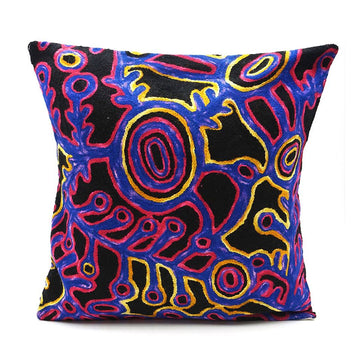 A black wool cushion printed with red, blue and yellow artwork by Theo Hudson.