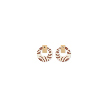 A pair of stud earrings with a circle printed with brown artwork by Murdie Morris.