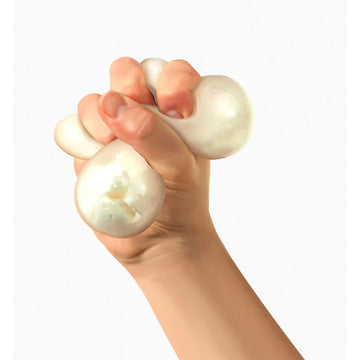 A white stress ball inside a cube box with the text 'Snow Ball Nee Doh' written on the front.