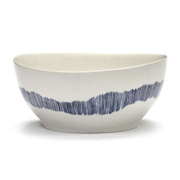 Side view of a white ceramic bowl with blue stripes.