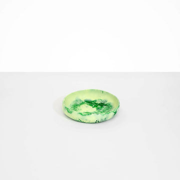 A small shallow bowl made from green resin.