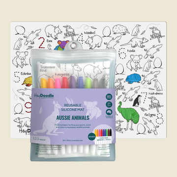 Reusable silicone mat with colorful markers and an Aussie Animals coloring sheet on a beige background.