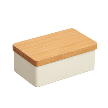 A porcelain butter dish in white with a bamboo lid.