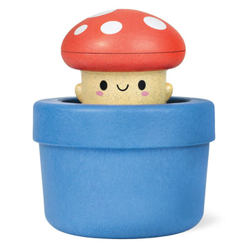 A bath toy shaped like a mushroom in a blue pot.