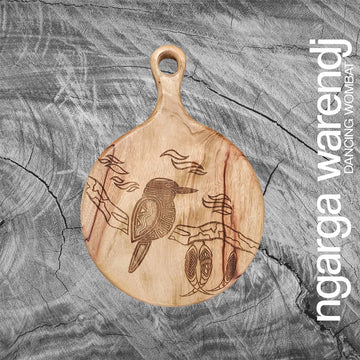 Wooden round board with engraved design of a kookaburra on a textured gray background, featuring the brand 'ngaga warendj'.