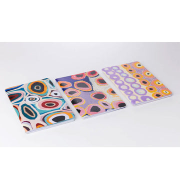A set of three notebooks each printed with different artwork by Martumili artists.