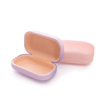 Three small hard shell cases in purple, peach and mint green.