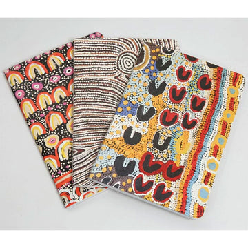 Three notebooks each printed with different artwork from the Yarliyil art centre.