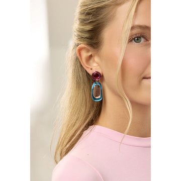 A pair of drop earrings with round abstract shapes in different colours.