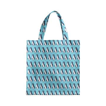 Tote bag with penguin pattern on a light blue background.