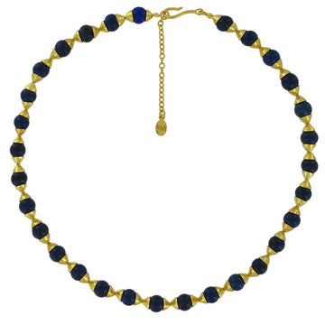 A beaded necklace with round blue lapis beads and cone shaped gold pieces in between.