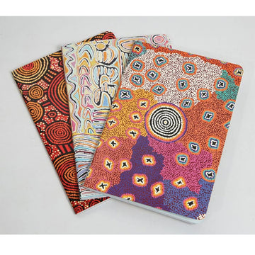 Three notebooks each printed with different artwork from Warlu artists.