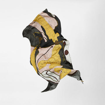 Abstract scarf with black, yellow, and beige patterns on a white background.