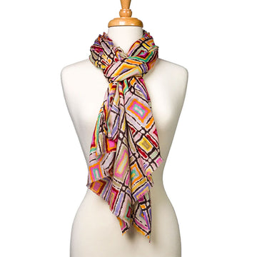 A woollen scarf printed with artwork by Lynette Singleton wrapped around the neck of a mannequin.