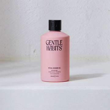 A pink bottle with the heading 'Gentle Habits' and product information written in black.