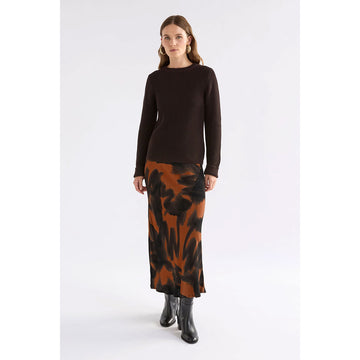 A women's skirt printed with a tortoise shell print in brown and black.