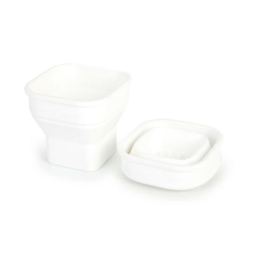A collapsible cup shown in white in both its full form and collapsed form.