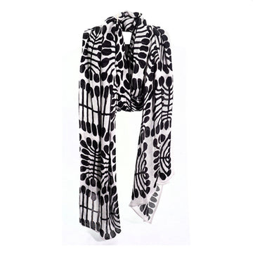 A black and white scarf printed with artwork by Mitjili Napurrula.