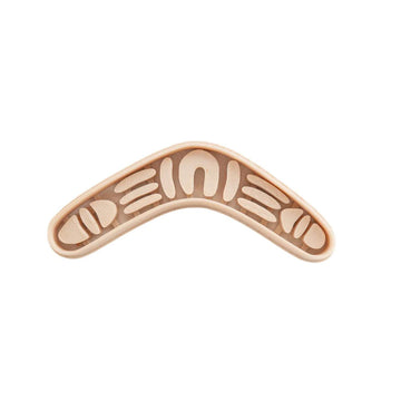 A boomerang shaped cutter with Indigenous symbols inside.