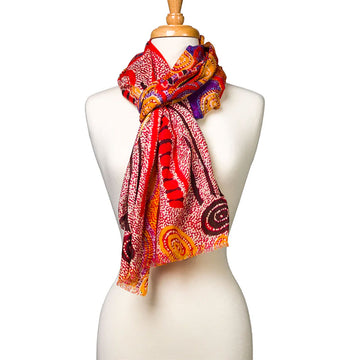 A woollen scarf printed with artwork by Otto Sims wrapped around the neck of a mannequin.