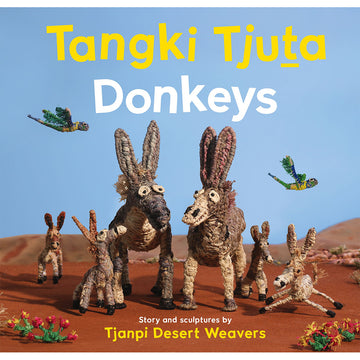 'Tangki Tjuta Donkeys' book cover featuring a picture of a family of donkeys made from woven sculptures in a desert setting.