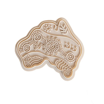 A cutter shaped like the map of Australia with Indigenous symbols inside.