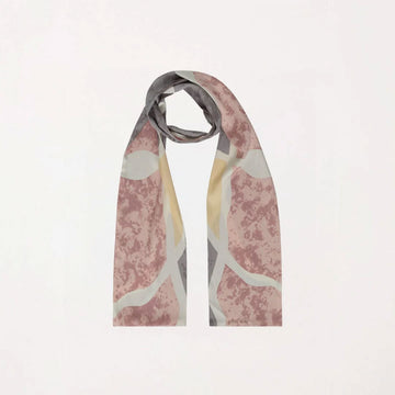 Scarf with abstract pattern on a light pink background.