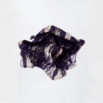 Marbled black and white stone scarf on a light gray background.