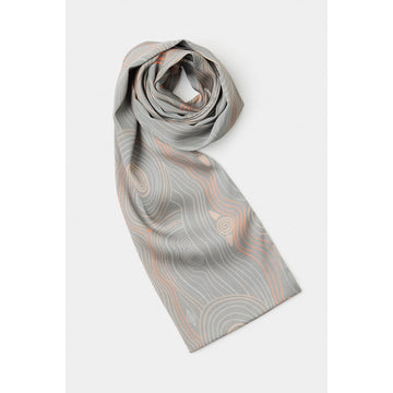 Gray patterned scarf on a white background with most of the scarf rolled up.